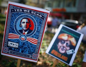 Placards showing U.S. President Obama and German Chancellor Merkel are seen during demonstration against NSA and in support of Snowden in Frankfurt