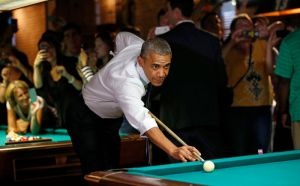U.S. President Obama shoots pool during stop in a bar in Denver
